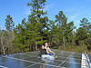 John S. Quarterman and Gretchen Quarterman with farm workshop solar panels at Okra Paradise Farms