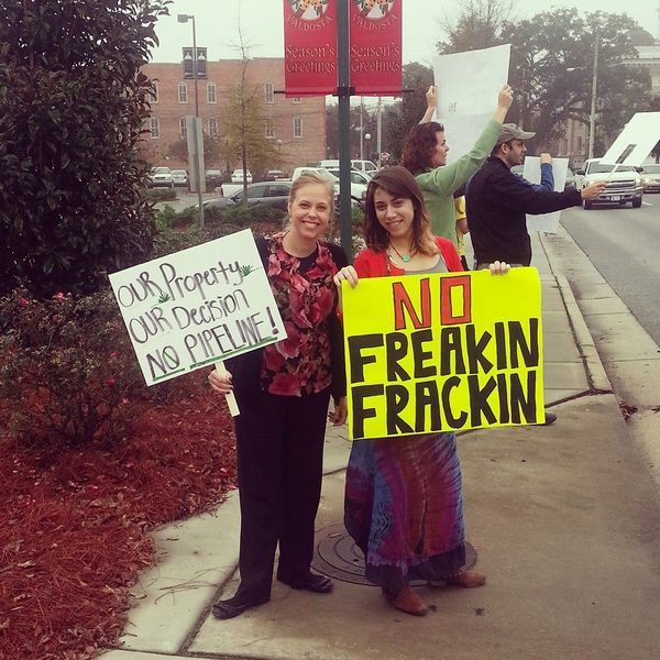 Our Property, Our Decision, No Pipeline (Ashlie Marie Prain), No Freakin Frackin (Mary Booker), in My fellow protesters and me at the spectra energy commissioner's meeting, by Mary Booker, for Lowndes Area Knowledge Exchange, 9 December 2013