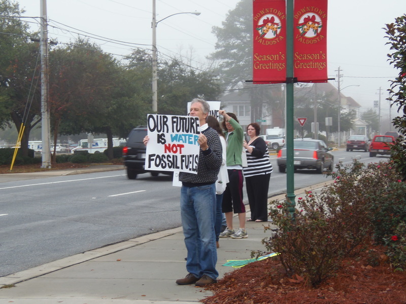 Our Future is Water, Not Fossil Fuels, Matthew Richard, Karen Noll, Andi Ray Drake, in No pipeline no fracking: protest before Spectra at Lowndes County Commission, by Gretchen Quarterman, for Lowndes Area Knowledge Exchange (LAKE), 9 December 2013