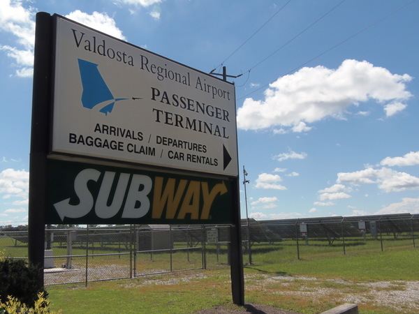 Solar panels behind passenger terminal sign