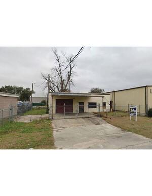 [Photograph, fence and garage door]