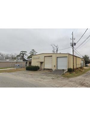 [Photograph, double garage doors]