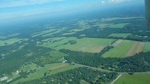 [NNW across tower on SW 121st Ave: more land owned by miners? 09:43:19, 29.9454194, -82.4099449]